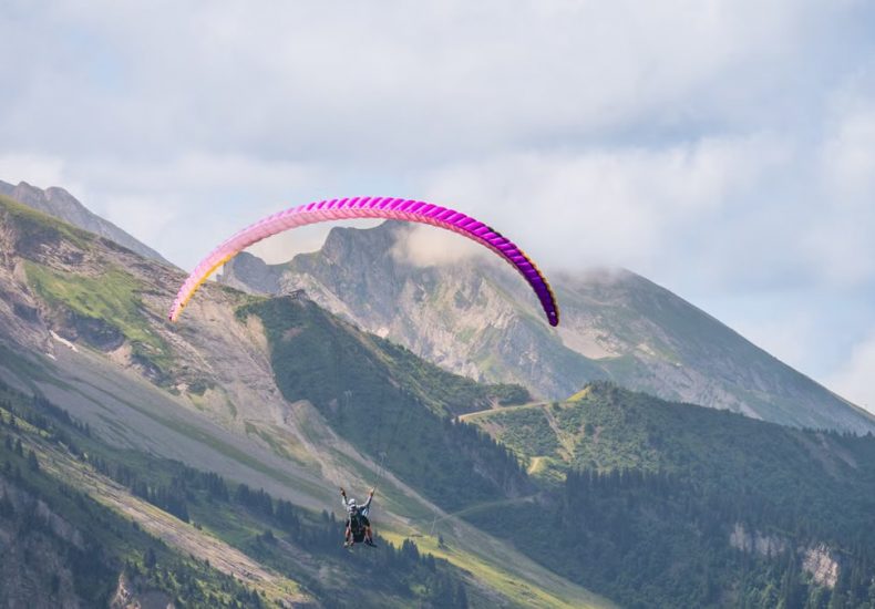 Experience thrilling paragliding over stunning mountain landscapes, perfect for adventure seekers.